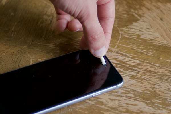 Foto von einem aufgerollten Stück Klebeband, das zum Reinigen eines iPhones verwendet wird